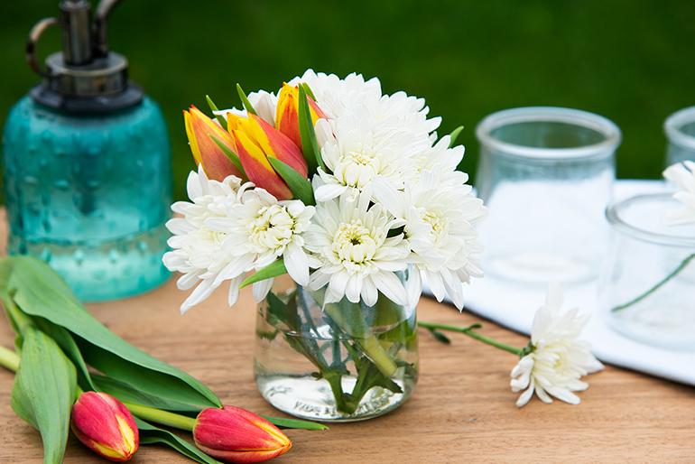 Oui by Yoplait yogurt glass pot used as a vase for a flower arrangement.