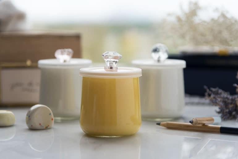 Three Oui by Yoplait yogurt jars painted and given lids with crystal handles.