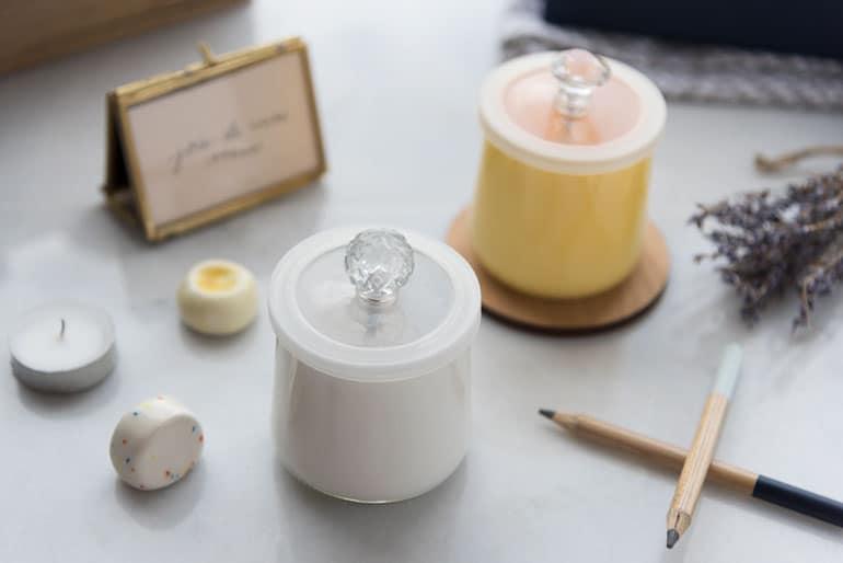 Two Oui by Yoplait yogurt jars painted and embellished with bespoke lids.